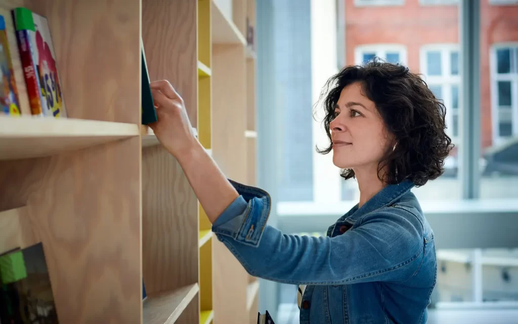 girl-choosing-book-from-shelf