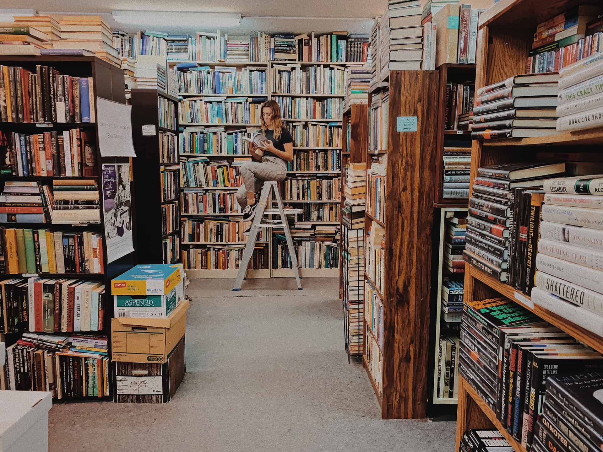 girl-sitting-in-ladder-inside-library