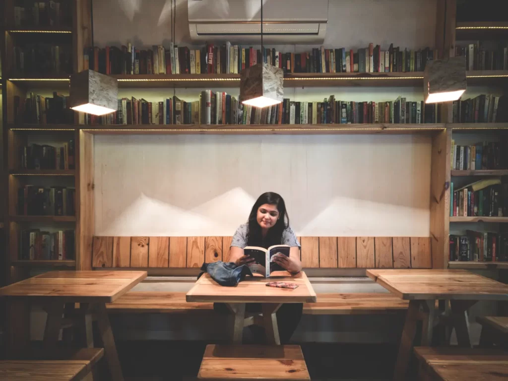 girl-sitting-reading-middle-two-tables