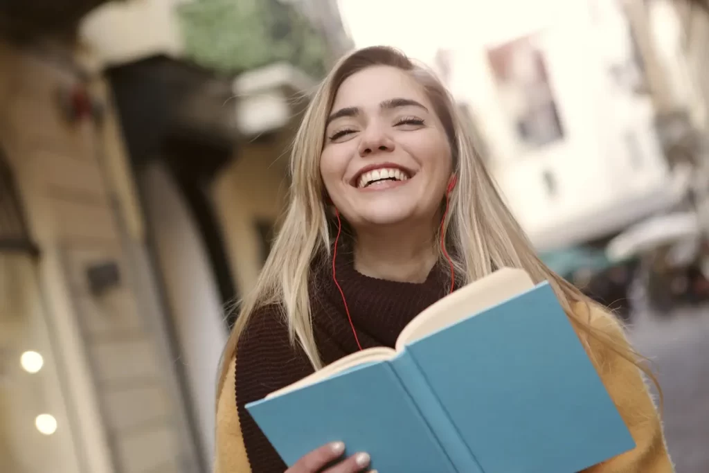 girl-wearing-violet-sitting-hugging-book