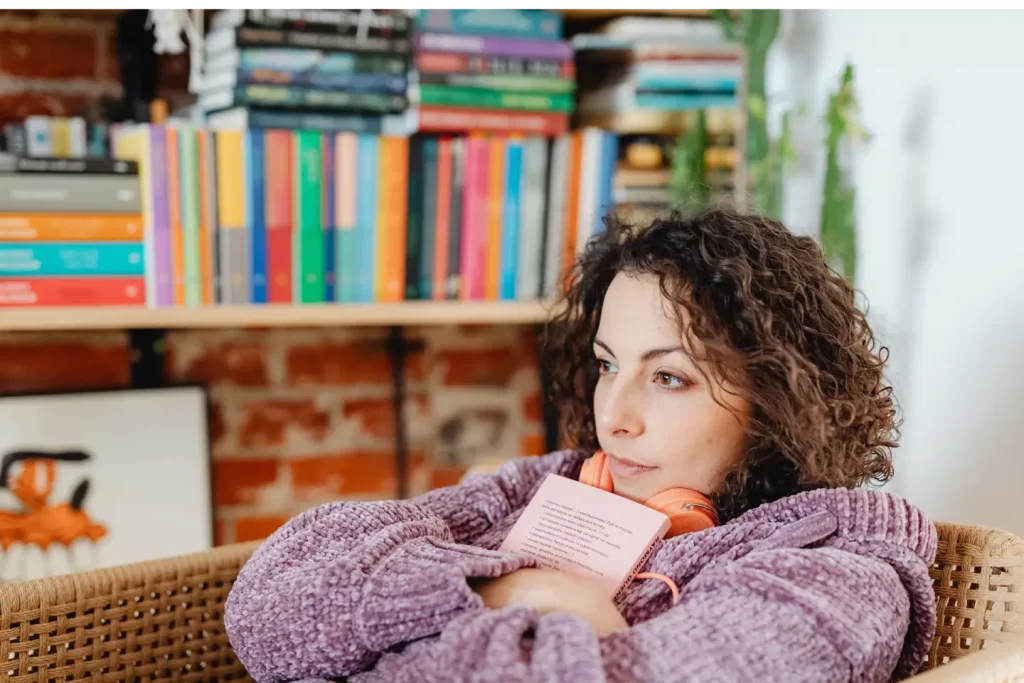 girl-wearing-violet-sitting-hugging-book