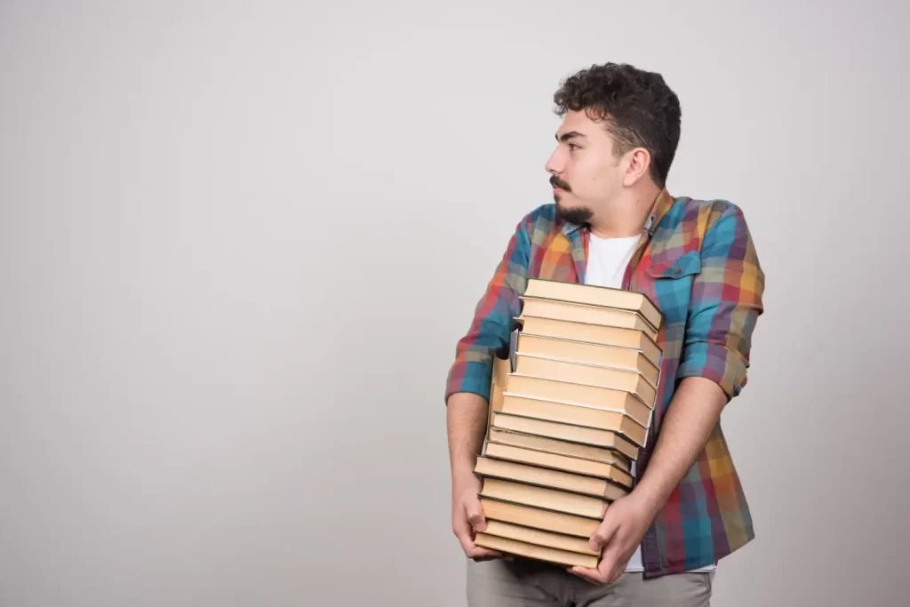 man-carrying-stack-books