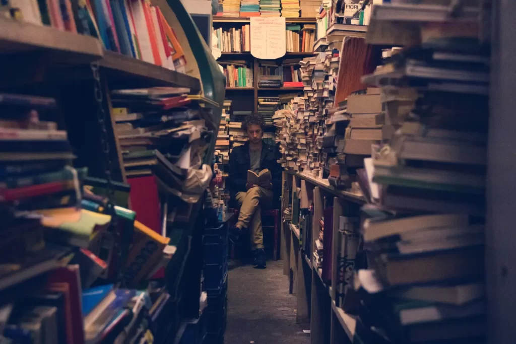 man-reading-middle-surrounded-books