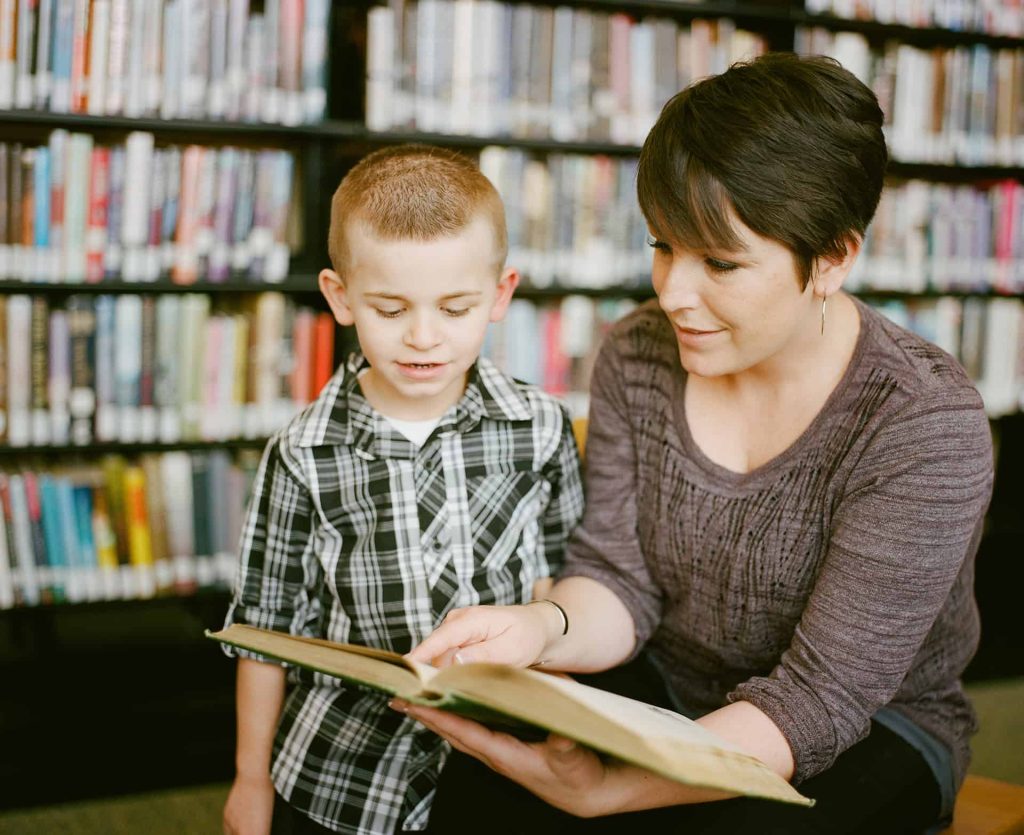 mother-teaching-son-read-book