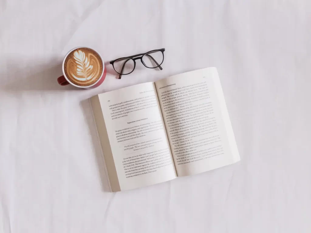 open-book-beside-coffee-glasses