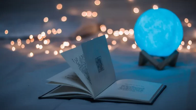 open-book-with-yellow-lights-and-blue-moon-light