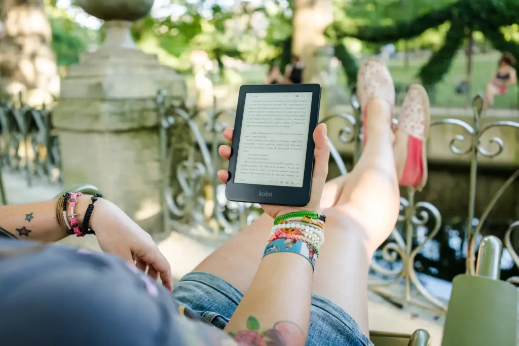 person-holding-kindle-tablet-outside