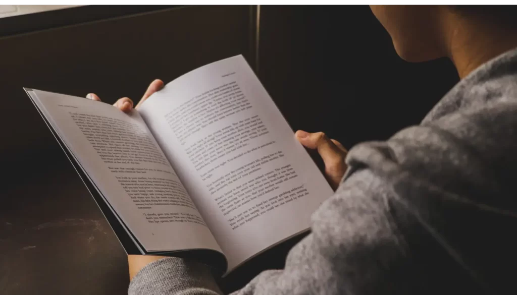 person-wearing-grey-reading-book-open