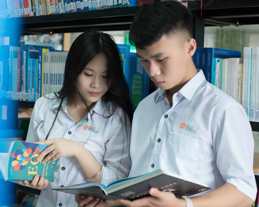 two-students-reading-book-in-library