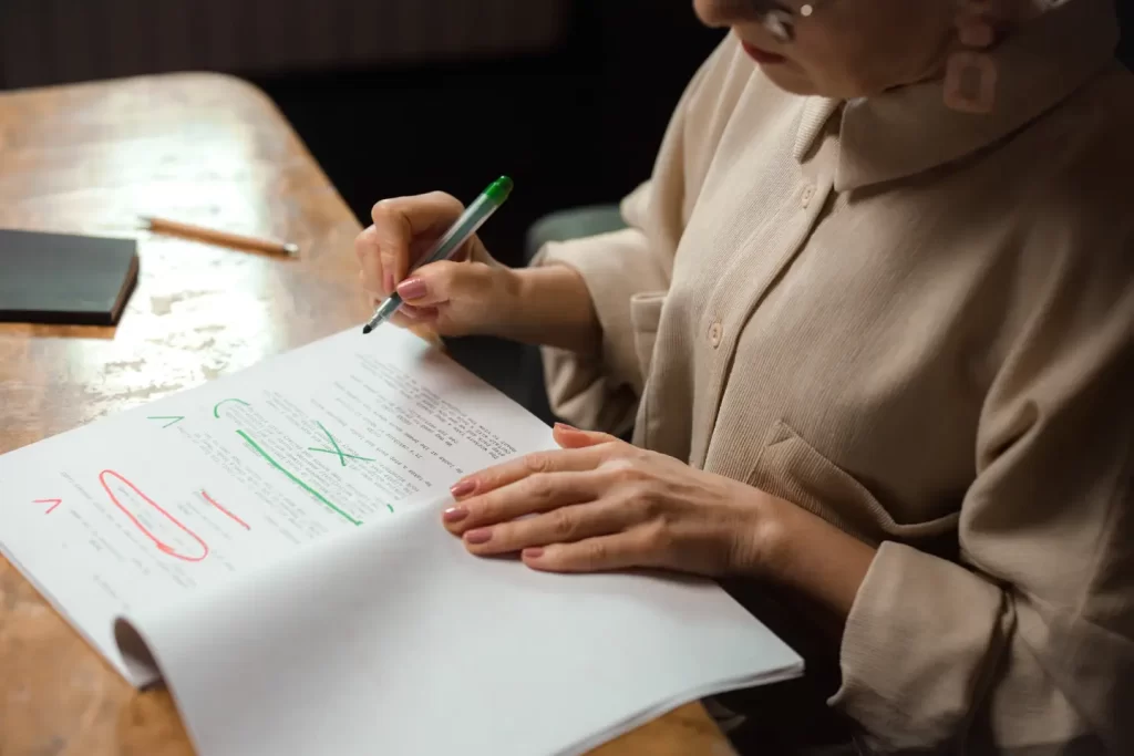 woman-correcting-page-with-colored-pen