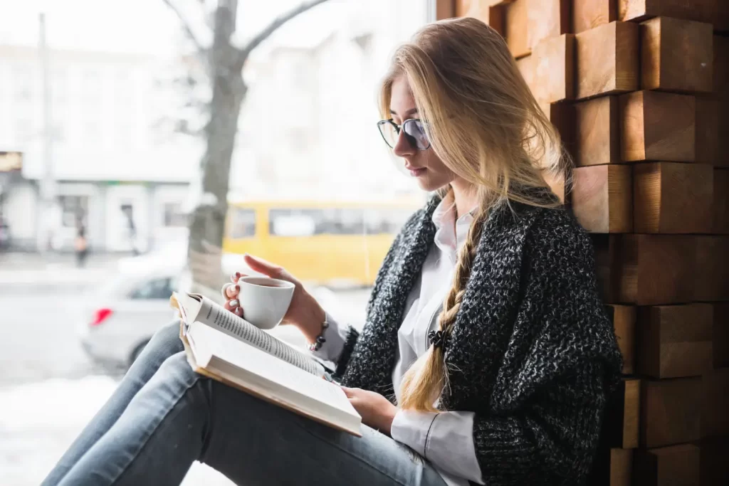 woman-with-cup-reading-near-window