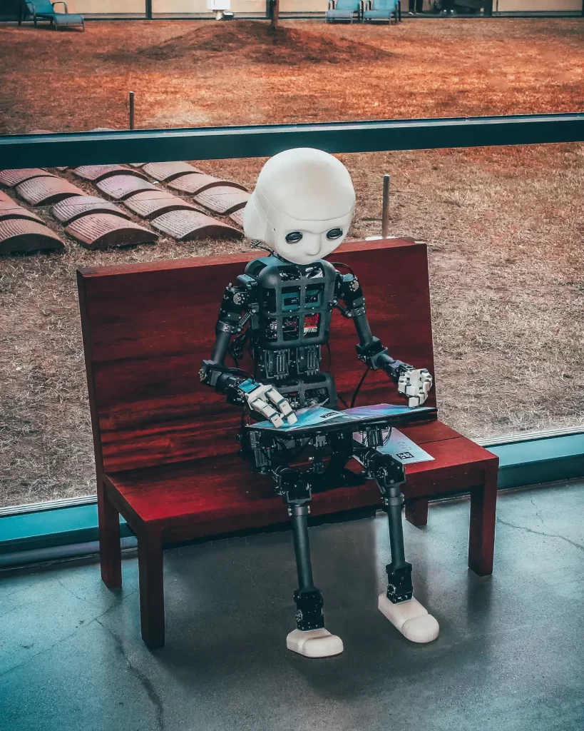 black-and-white-robot-toy-on-red-wooden-table