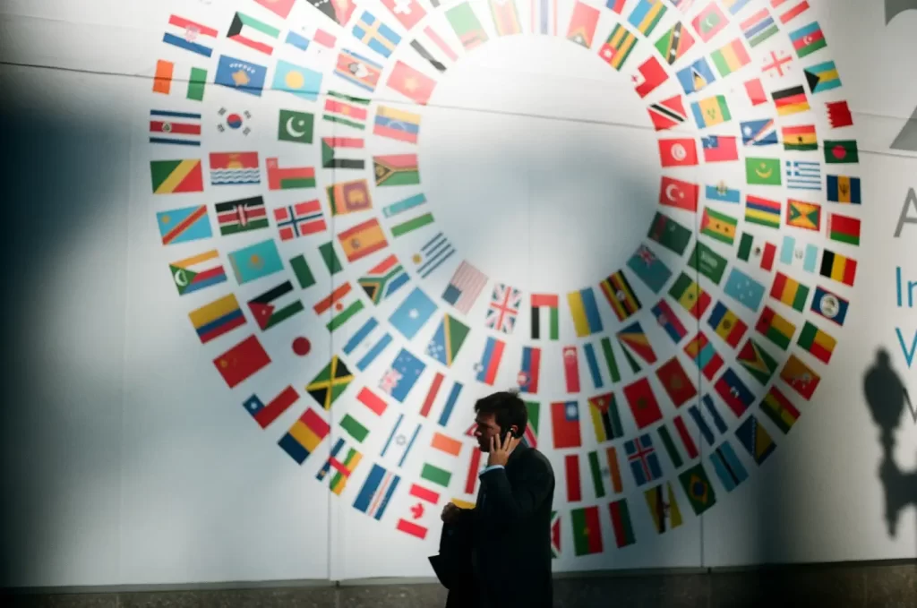 man-in-black-coat-standing-near-round-white-red-and-blue-wall