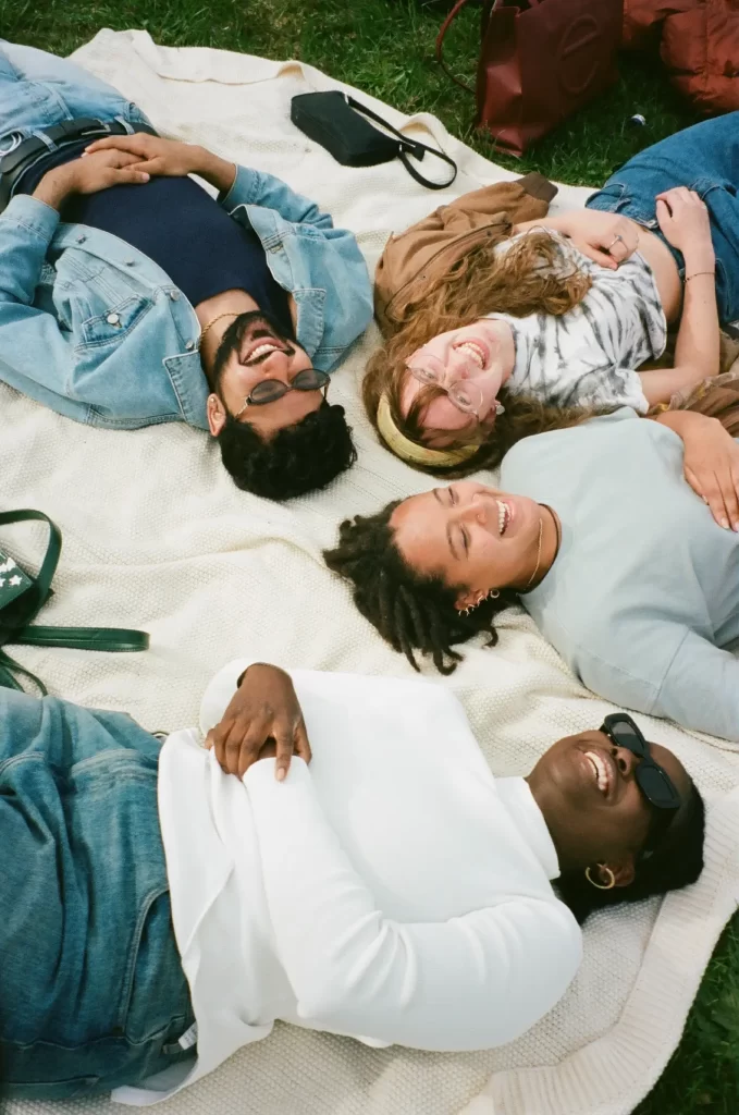 man-in-blue-button-up-shirt-lying-on-white-bed