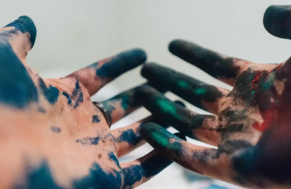 person-hand-with-green-and-blue-paint