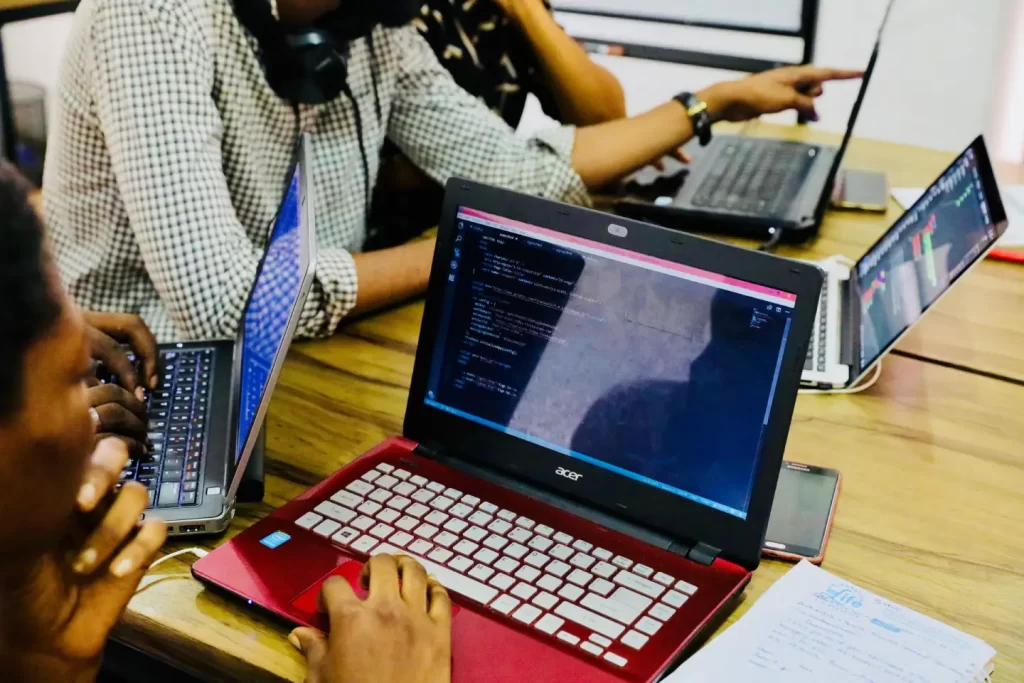 person-using-black-and-red-acer-laptop-computer-on-table