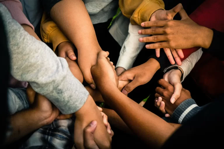 a-group-of-people-holding-hands