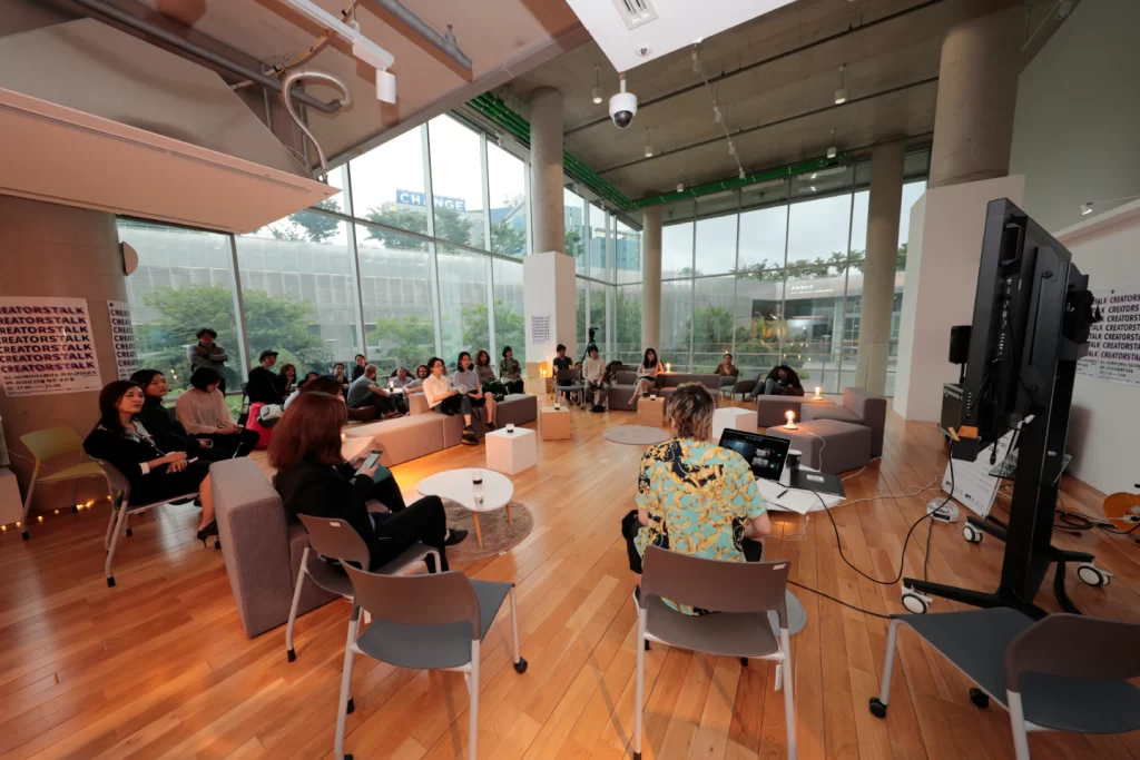 a-group-of-people-sitting-in-chairs-in-a-room