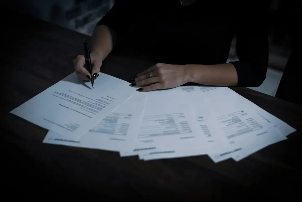 a-woman-sitting-at-a-table-with-lots-of-papers