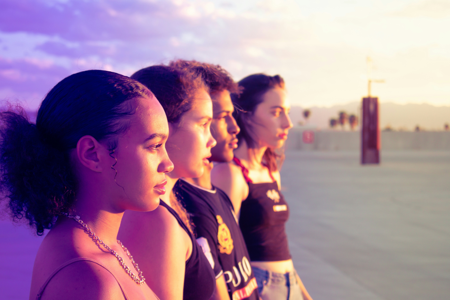 four-women-standing-on-pathway-looking-side