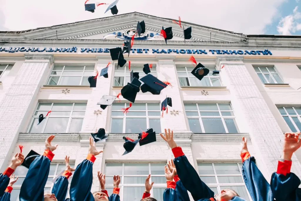 group-of-fresh-graduates-students-throwing-their-academic-hat-in-the-air