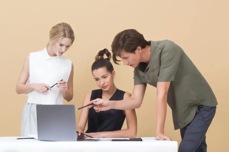 man-teaching-woman-while-pointing-on-gray-laptop