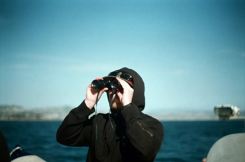 man-with-binoculars-in-boat