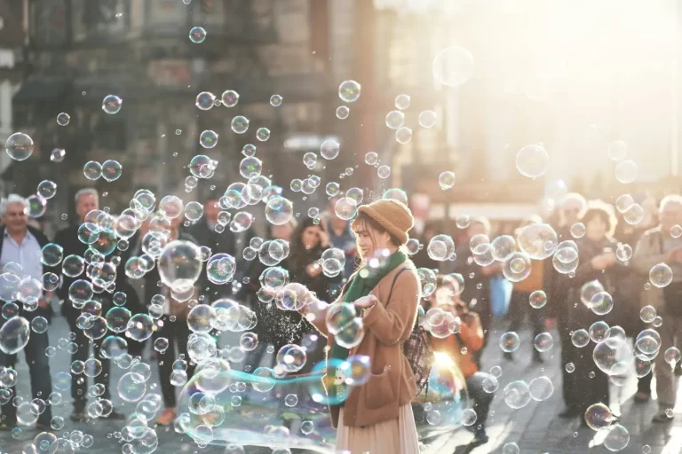 woman-standing-outdoor-surrounded-by-bobbles-during-daytime