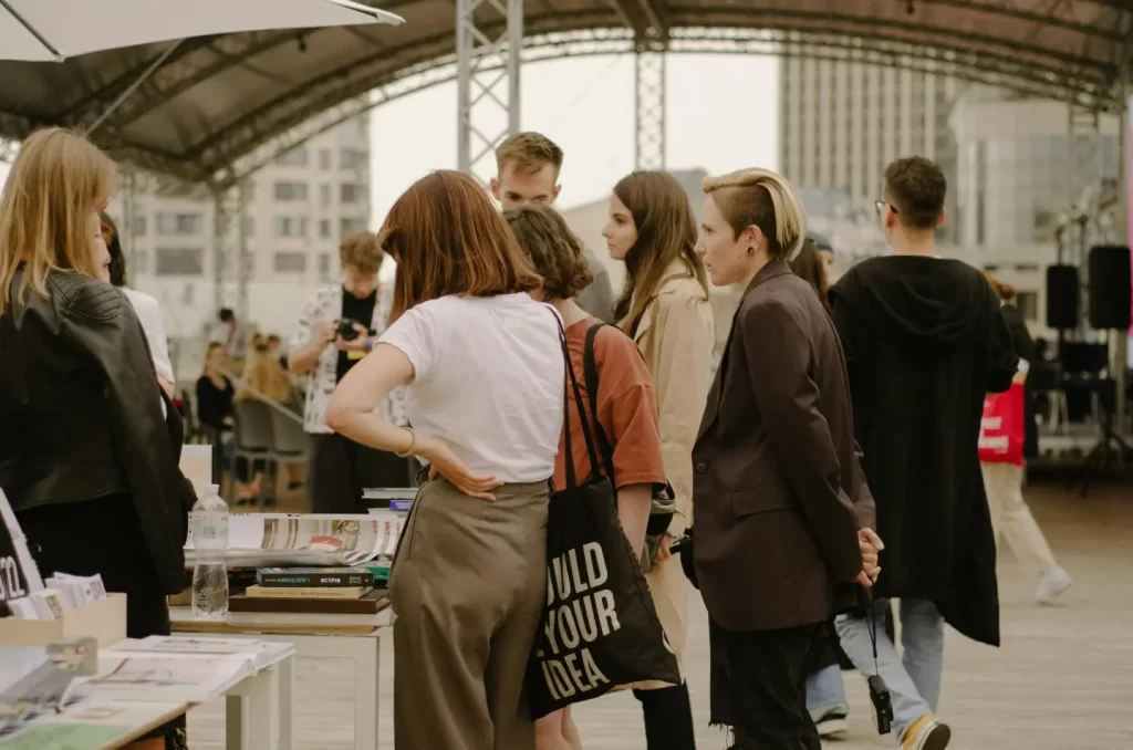 a-group-of-people-standing-around-a-table