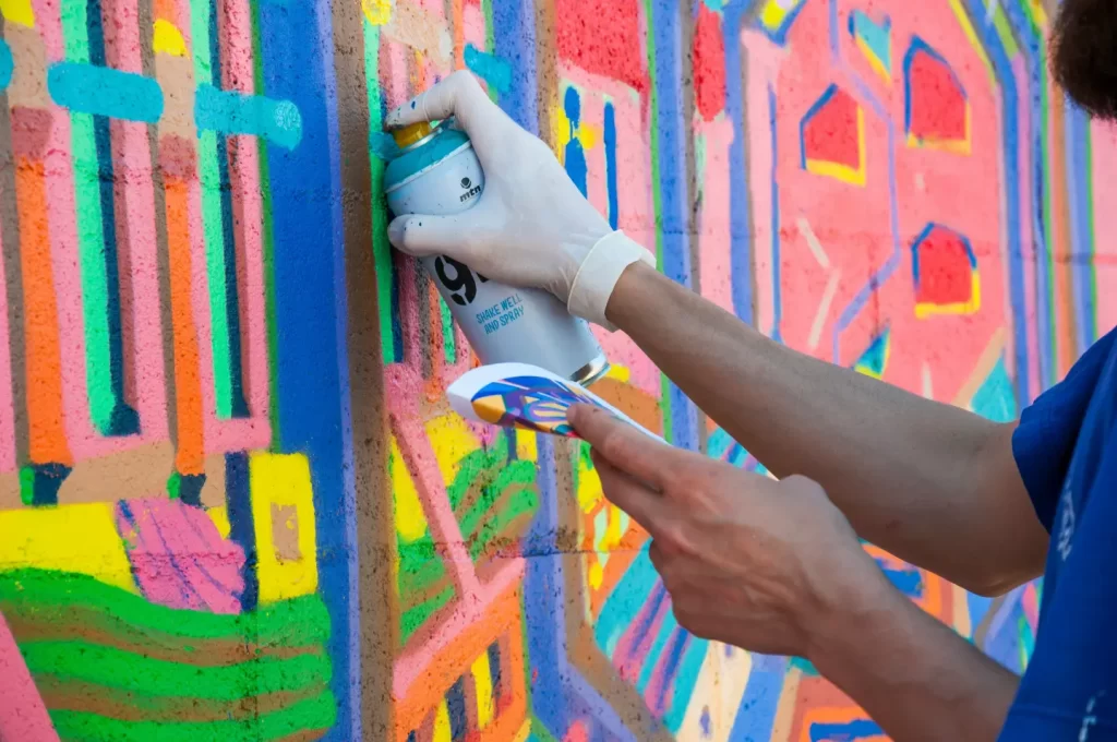 a-person-spray-painting-a-wall-with-colorful-paint