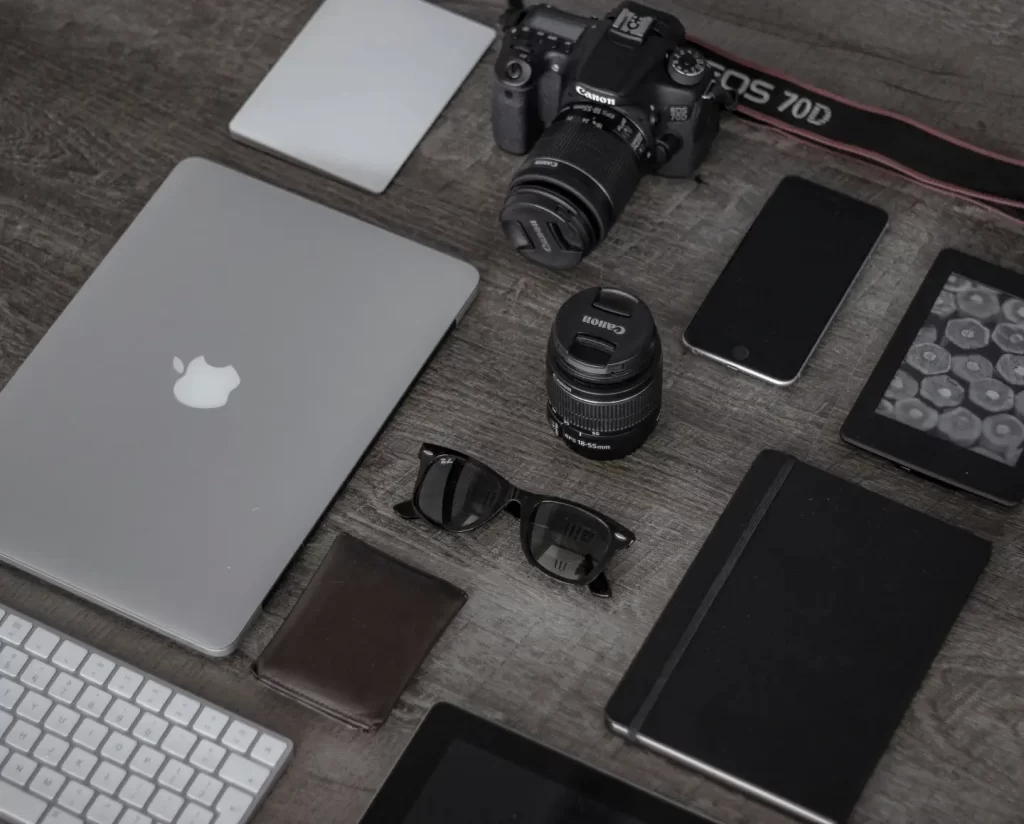 ipad-near-sunglasses-wallet-and-dslr-camera