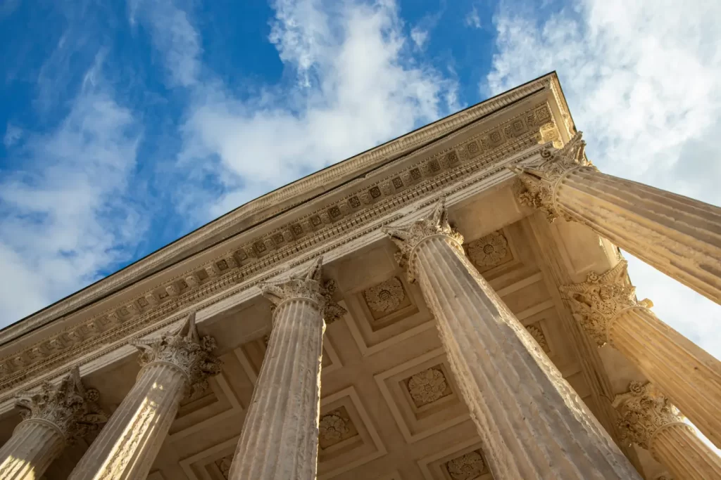 the-columns-of-a-building-against-a-blue-sky