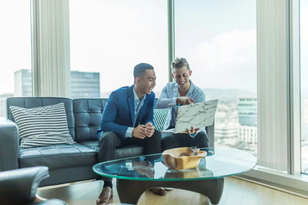two-men-in-suit-sitting-on-sofa